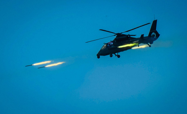 An attack helicopter fires rockets during a live-fire exercise off the country's southeastern coast on April 18, 2018. [Photo: chinadaily.com.cn]