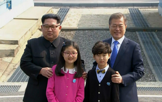 In this image taken from video provided by Korea Broadcasting System (KBS), North Korean leader Kim Jong Un, left, and South Korean President Moon Jae-in, right, pose with children as Kim crossed the border into South Korea for their historic face-to-face talks, in Panmunjom Friday, April 27, 2018. [Photo: AP]