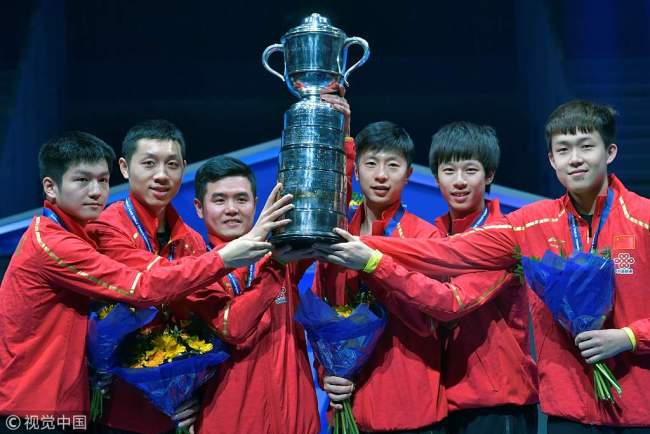 China's team members pose with their trophy on the podium after winning over Germany their men's final at the World Team Table Tennis Championships in Halmstad, Sweden, on May 6, 2018. [Photo: VCG]