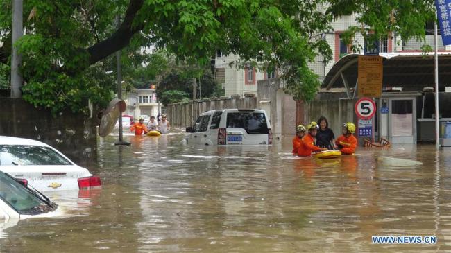 Rescue workers evacuate flood-affected residents in Xiamen, southeast China's Fujian Province, May 7, 2018.