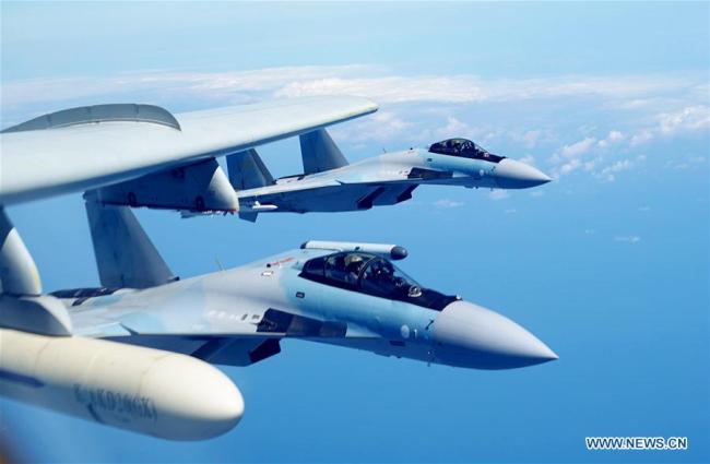 Two Su-35 fighter jets and a H-6K bomber fly in formation on May 11, 2018. The People's Liberation Army (PLA) air force conducted patrol training over China's island of Taiwan on Friday. Su-35 fighter jets flew over the Bashi Channel in formation with the H-6Ks for the first time, which marks a new breakthrough in island patrol patterns, said Shen Jinke, spokesperson for the PLA air force. [Photo: Xinhua]