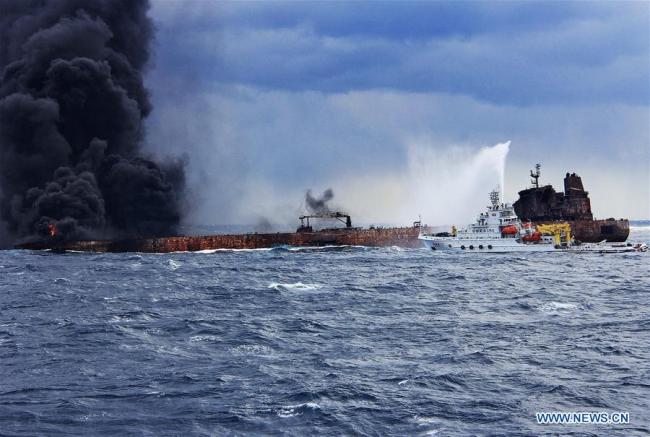Rescuers spray foam to extinguish flames on the stricken oil tanker SANCHI off the coast of east China's Shanghai, Jan. 12, 2018. Shanghai Maritime Safety Administration said there is still a large fire on the Panama-registered oil tanker SANCHI. It is likely to explode and sink, the administration said at a press conference on Friday. [Photo: Xinhua]