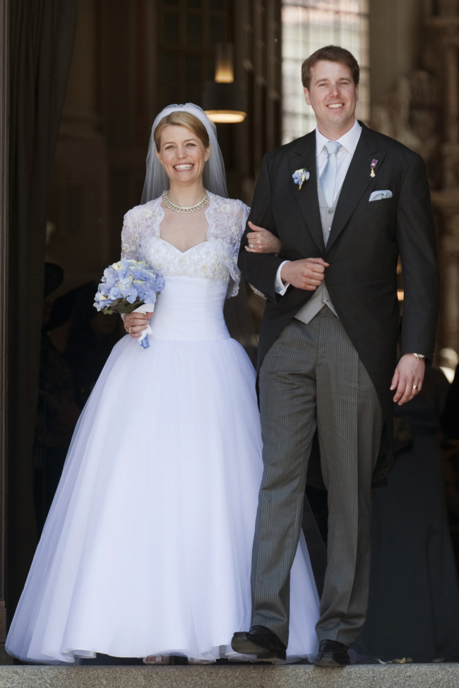 Hubertus, Prince of Saxony Coburg and Gotha, right, leads his American wife Kelly Rondestvedt out of St. Moriz church in Coburg, Germany, following their wedding on May 23, 2009. About 400 guests attended the wedding of the prince and the 34-year-old from Pensacola, Florida. [File Photo: AP/Eckehard Schulz]
