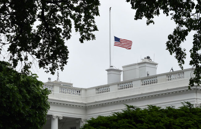 The American flag is lowered to half-staff at the White House in Washington, Friday, May 18, 2018. President Donald Trump ordered flags to be flown at half-staff to honor the victims in the shooting at Santa Fe High School in Texas. [Photo: AP/Susan Walsh]