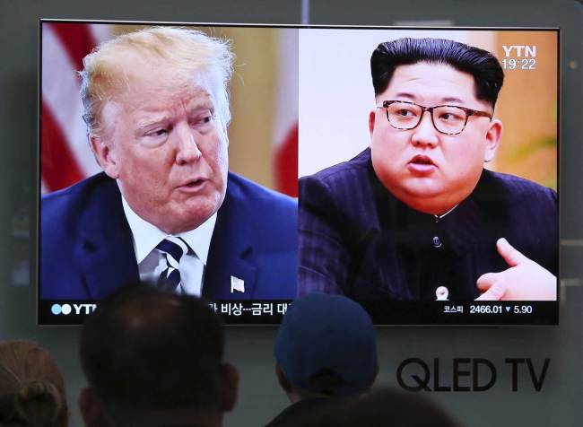 People watch a TV screen showing file footage of U.S. President Donald Trump, left, and North Korean leader Kim Jong Un during a news program at the Seoul Railway Station in Seoul, South Korea. [File photo: AP]
