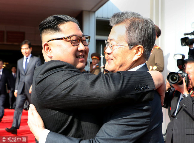 South Korean President Moon Jae-in bids fairwell to North Korean leader Kim Jong Un as he leaves after their summit at the truce village of Panmunjom, North Korea, in this handout picture provided by the Presidential Blue House on May 26, 2018. [Photo: VCG]