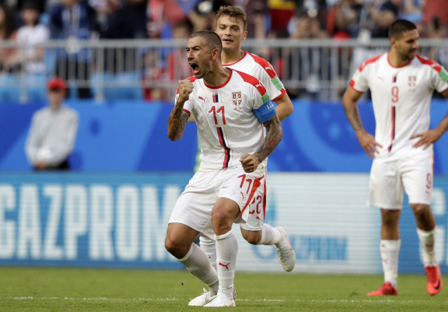 Serbia's Aleksandar Kolarov celebrates after scoring the opening goal during the group E match between Costa Rica and Serbia at the 2018 soccer World Cup in the Samara Arena in Samara, Russia, Sunday, June 17, 2018. [Photo: AP/Mark Baker]