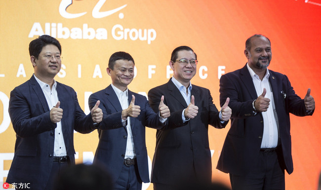 Jack Ma (2-L), the founder and executive chairman of Chinese e-commerce company Alibaba Group, Malaysian Finance Minister, Lim Guan Eng (2-R), Malaysian Communications and Multimedia Minister, Gobind Deo (R) and Bai Tian (L), China's ambassador to Malaysia, give the thumbs up during the opening of the Alibaba group office in Kuala Lumpur, Malaysia, 18 June 2018. Alibaba Group opened its office in Malaysia, marking a new chapter of a company's deepening strategic cooperation with Malaysia, the first eWTP (Electronic World Trade Platform) hub outside of China. [Photo: EPA/Ahmad Yusni]