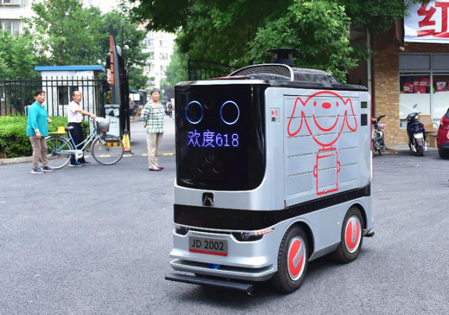 A JD.com courier robot on a road in Haidian District, Beijing, June 18, 2018. [Photo: zjol.com.cn]