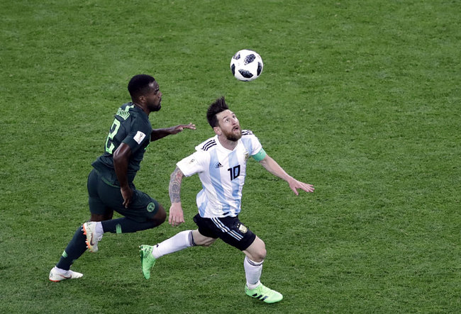 Argentina's Lionel Messi runs for the ball with Nigeria's Bryan Idowu, left, during the group D match between Argentina and Nigeria, at the 2018 soccer World Cup in the St. Petersburg Stadium in St. Petersburg, Russia, Tuesday, June 26, 2018. [Photo: AP]