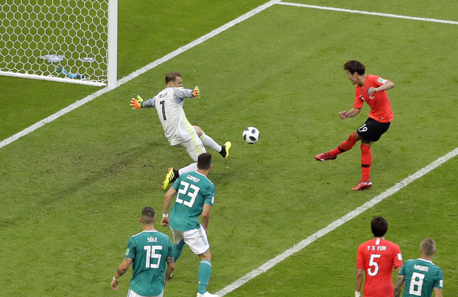 South Korea's Kim Young-gwon, top right, scores the opening goal during the group F match between South Korea and Germany, at the 2018 soccer World Cup in the Kazan Arena in Kazan, Russia, Wednesday, June 27, 2018. [Photo: AP]