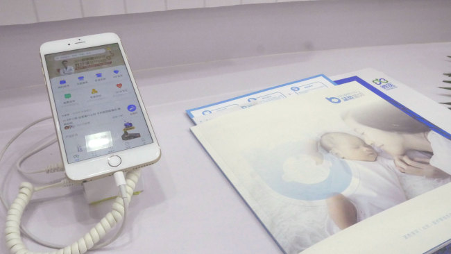 The homepage of WeDoctor app showed on the phone [Photo: China Plus/Li Yi]