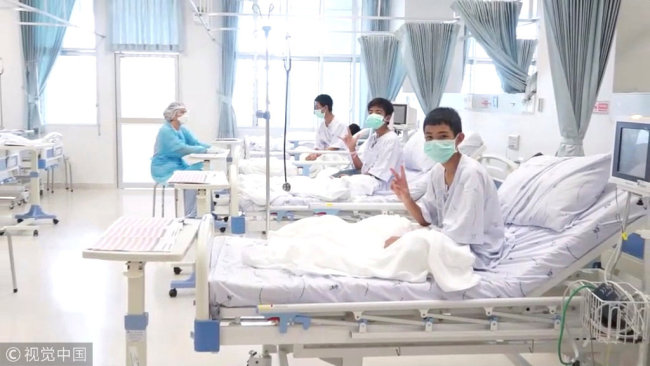 Boys rescued from the Thai cave wear masks and rest at a hospital in Mae Sai, Chiang Rai province, Northern Thailand, in a still image taken from a July 11, 2018 handout video. [Photo: VCG]
