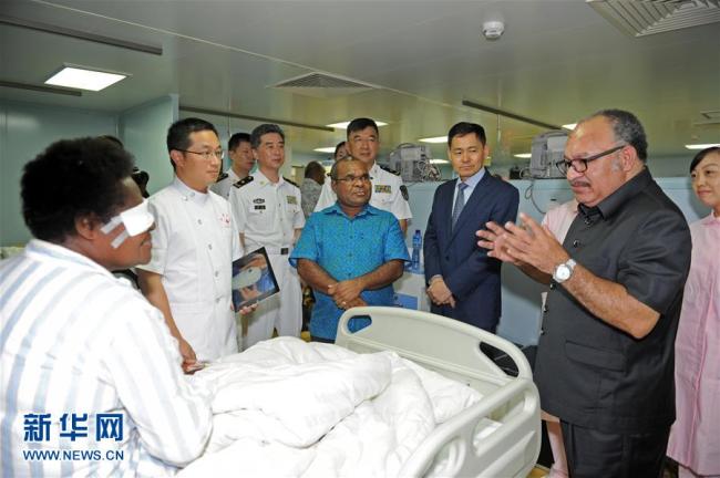 Papua New Guinea's Prime Minister Peter O'Neill (R1, front) visits Chinese naval hospital ship Ark Peace in Port Moresby on Saturday, July 14, 2018. [Photo: Xinhua]