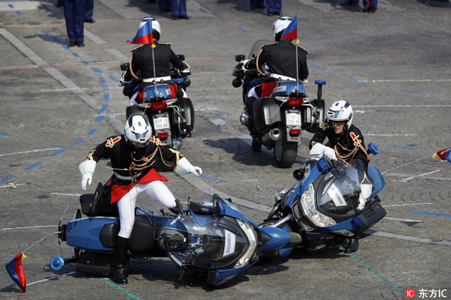 Two police motorcycles crash during a demonstration as part of the Bastille Day parade on the Champs Elysees avenue in Paris, France, Saturday, July 14, 2018. [Photo: IC]