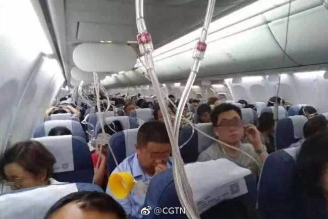 Passengers put on their oxygen masks after an Air China plane plunged 23,000 feet mid-air on July 10, 2018. [Photo: Weibo/CGTN]