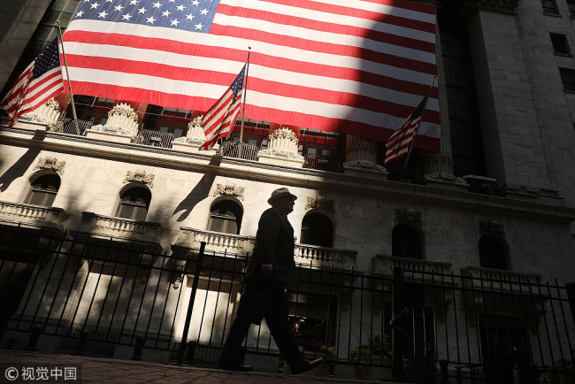A man walks by the New York Stock Exchange (NYSE) on July 12, 2018 in New York City. [File Photo: VCG]
