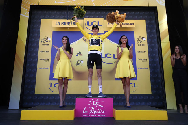 Stage winner Britain's Geraint Thomas and new overall leader celebrates on the podium after the eleventh stage of the Tour de France cycling race over 108.5 kilometers (67.4 miles) with start in Albertville and finish in La Rosiere Espace San Bernardo, France. (AP Photo/Christophe Ena )