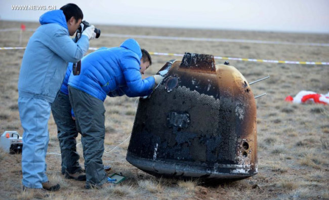 The return capsule of the Chang'e-5 T1 spacecraft touches down at the designated landing area in Siziwang Banner, Inner Mongolia Autonomous Region, on November 1, 2014. [File photo: Xinhua]