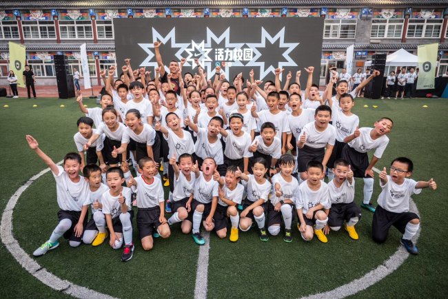 Portuguese football player Cristiano Ronaldo of Juventus FC, center back, poses for photos with young students during the Active Schools Sports Camp at a primary school in Beijing, China, 19 July 2018. (Photo: dfic)