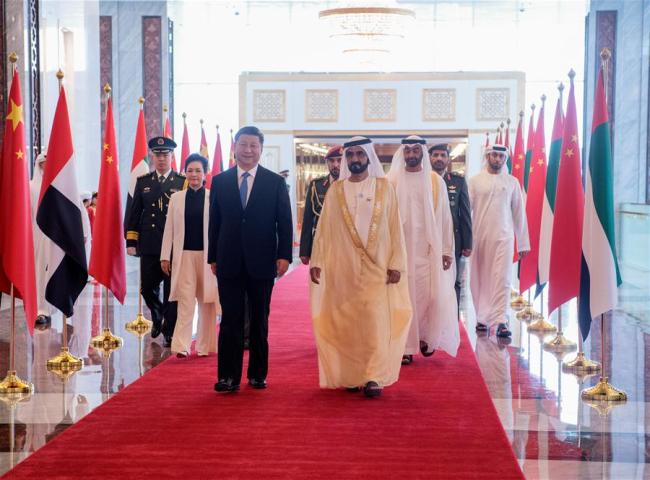 Chinese President Xi Jinping and his wife Peng Liyuan, accompanied by the United Arab Emirates (UAE) Vice President and Prime Minister Sheikh Mohammed bin Rashid Al Maktoum and the Crown Prince of Abu Dhabi Sheikh Mohammed bin Zayed Al Nahyan, head for a reviewing hall in Abu Dhabi, the UAE, July 19, 2018. Xi arrived here on Thursday for a state visit to the UAE. The UAE's vice president hosted a welcome ceremony for the Chinese president at the airport. [Photo: Xinhua/Li Xueren]