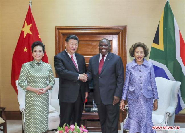 Chinese President Xi Jinping (2nd L) and his wife Peng Liyuan (1st L) pose for photos with South African President Cyril Ramaphosa (2nd R) and his wife Tshepo Motsepe ahead of the two leaders' talks in Pretoria, South Africa, July 24, 2018. [Photo: Xinhua/Xie Huanchi]