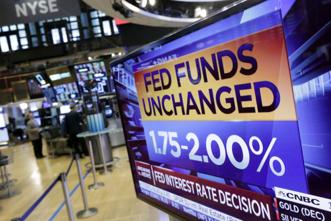 A screen on the floor of the New York Stock Exchange shows the rate decision of the Federal Reserve, Wednesday, Aug. 1, 2018. The Federal Reserve is leaving its benchmark interest rate unchanged while signaling further gradual rate hikes in the months ahead as long as the economy stays healthy. [Photo: AP/Richard Drew]