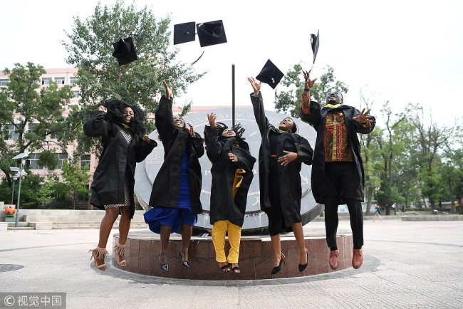 International students celebrate their graduation in Taiyuan University of Technology on June 29, 2018. [Photo/VCG]