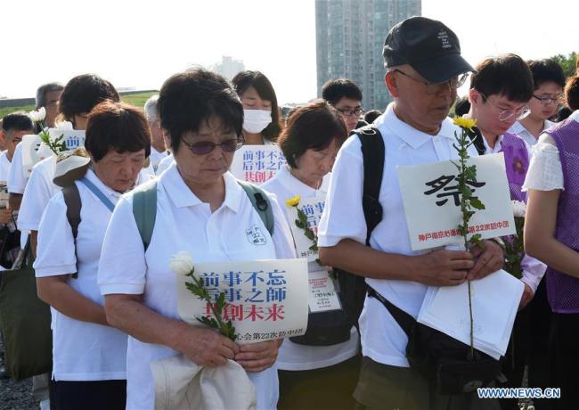 Members of a visiting Japanese delegation pay tribute to the victims in silence at The Memorial Hall of the Victims in Nanjing Massacre by Japanese Invaders in east China's Jiangsu Province, Aug. 15, 2018. 