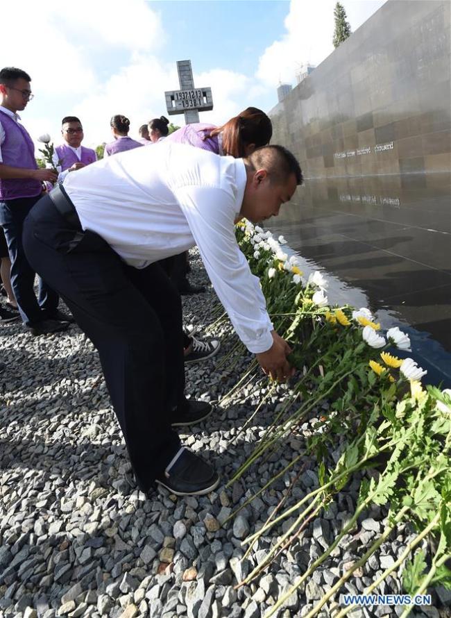 Citizens lay flowers at The Memorial Hall of the Victims in Nanjing Massacre by Japanese Invaders in east China's Jiangsu Province, Aug. 15, 2018.