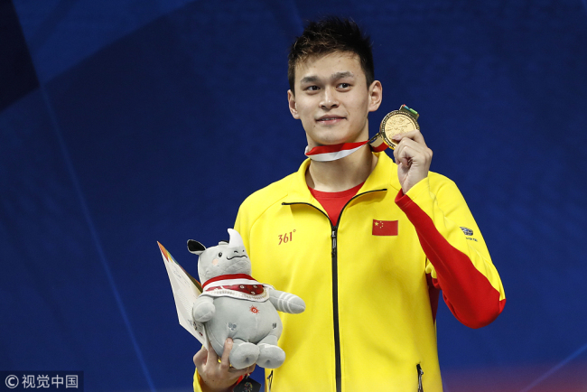 Gold medal winner Sun Yang wears a tracksuit from his personal brand sponsor at the medal ceremony for the men's 200 meter freestyle at the Asian Games in Jakarta on Sunday, August 19, 2018. [Photo: VCG]