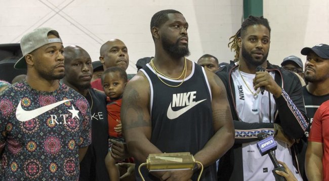 From left, New Orleans Saints Craig Robertson, Chris Banjo (holding his son, Terron Armstead and Cam Jordan attend the "Unity in Community" rally at Susan Park Playground which was organized as a "peaceful protest" after widely-circulated memo by Kenner Ben Zahn banning Kenner's recreation booster clubs from purchasing Nike gear, Kenner, La. Monday, Sept. 10, 2018. [Photo: AP/David Grunfeld /The Times-Picayune]