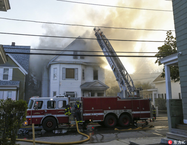 Firefighters battle blazes in a house in Lawrence, Massachusetts, USA, 13 September 2018.  [Photo: IC]