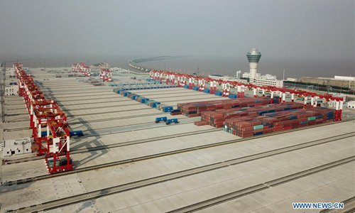 Photo taken on Dec. 10, 2017 shows the Phase IV of Shanghai Yangshan Deep Water Port in Shanghai, east China. Located at the south of Donghai Bridge, phase IV of the Yangshan Port, the world's biggest automated container terminal, started trial operations on Sunday. It covers 2.23 million square meters and has a 2,350-meter shoreline. Once it enters full operation, the fourth phase of the Yangshan Port will initially be able to handle 4 million TEUs (twenty-foot equivalent units). The number will expand to 6.3 million TEUs at a later stage. [Photo:Xinhua]