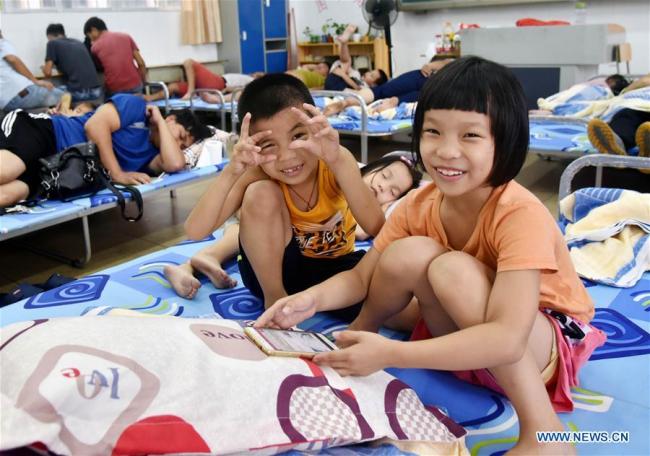 Children play in a temporary shelter at a primary school in Dongping Town of Yangjiang, south China's Guangdong Province, Sept. 16, 2018. Super Typhoon Mangkhut landed at 5 p.m. on Sunday on the coast of Jiangmen City, south China's Guangdong Province. Some 600 people from disaster-prone areas in Dongping have been relocated. [Photo: Xinhua]