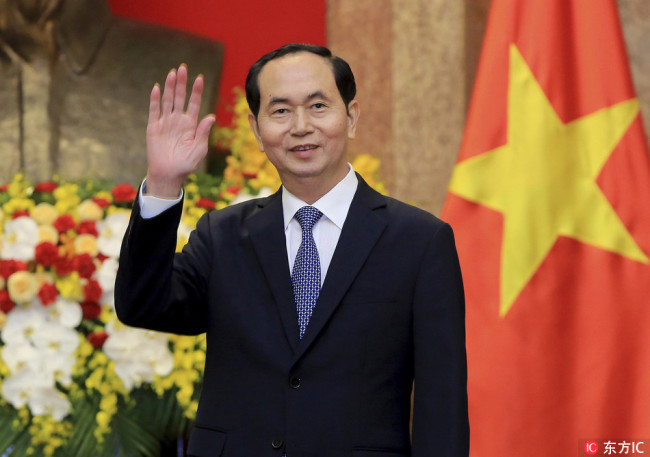 In this March 23, 2018, file photo, Vietnamese President Tran Dai Quang greets journalists as he waits for arrival of Russian Foreign Minister Sergei Lavrov at the Presidential Palace in Hanoi, Vietnam. Official media say Vietnamese President Tran Dai Quang has died at age 61 due to illness on Friday, Sept. 21, 2018. [File Photo: IC]