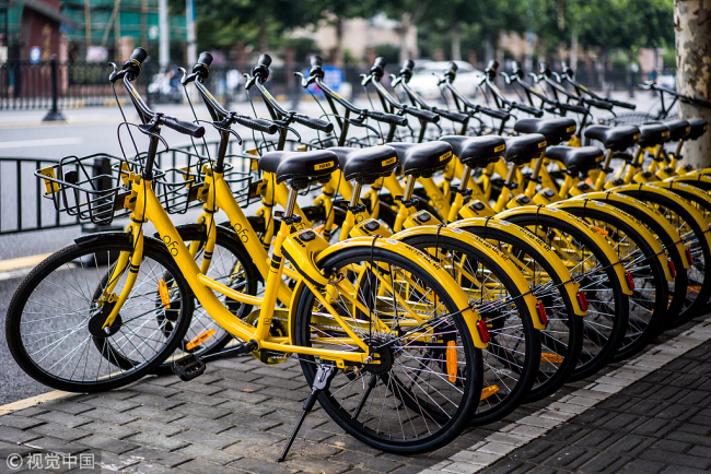 Shared bikes put on the side of a road in Shanghai [File photo: VCG]
