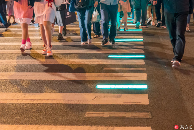 The photo, taken on October 10, 2018, shows an illuminated sidewalk in Shanghai. [Photo: VCG] 