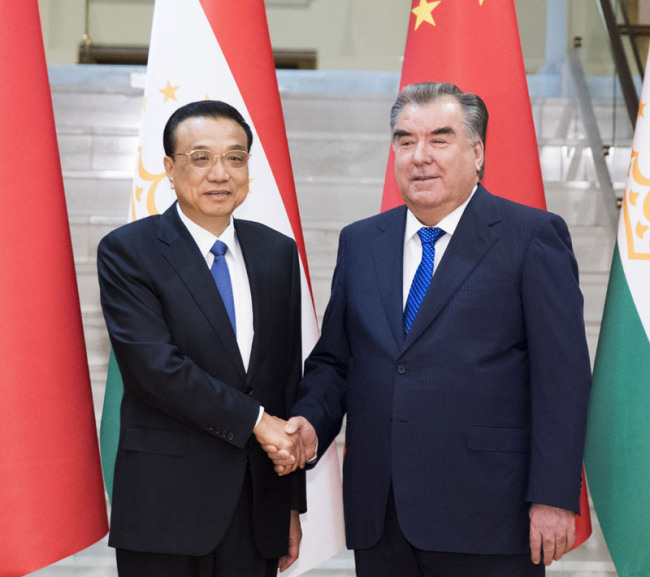 Chinese Premier Li Keqiang shakes hands with Tajik President Emomali Rahmon in the Tajik capital Dushanbe on Saturday, October 13, 2018. [Photo: gov.cn]
