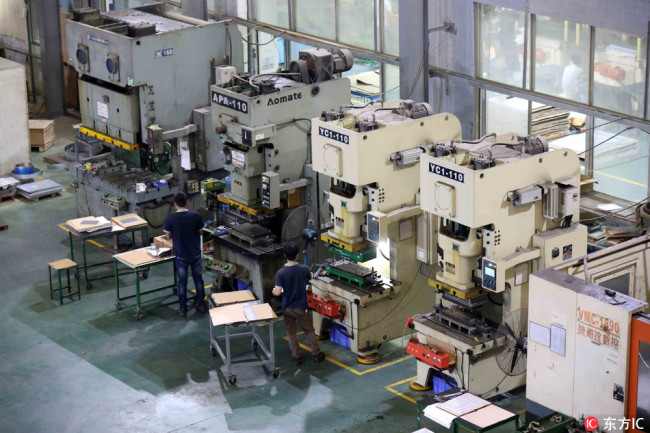 Workers work in a precision molding company in Guangdong Province. [File Photo: IC]