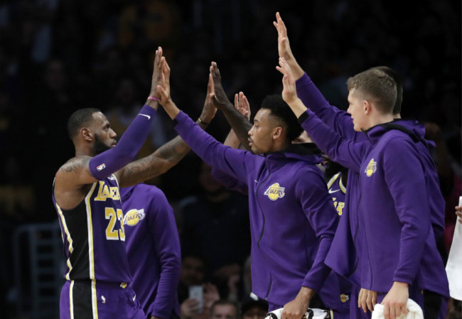 Los Angeles Lakers' LeBron James, left, high-fives teammates after scoring against the Dallas Mavericks during the first half of an NBA game on Wednesday, October 31, 2018, in Los Angeles. [Photo: AP]