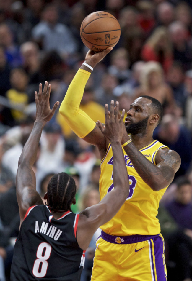 Los Angeles Lakers forward LeBron James, right, shoots over Portland Trail Blazers forward Al-Farouq Aminu during the first half of an NBA basketball game in Portland, Ore., Saturday, Nov. 3, 2018. [AP]