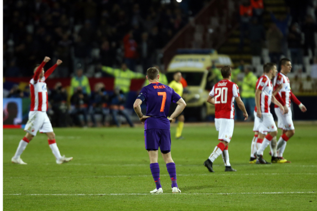Liverpool midfielder James Milner looks in dejection Red Star players celebrating after winning the Champions League group C soccer match between Red Star and Liverpool 2-0 at the Rajko Mitic stadium in Belgrade, Serbia, Tuesday, Nov. 6, 2018. [Photo: AP]