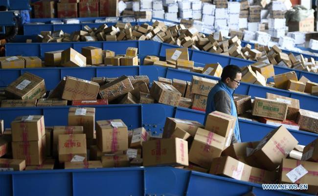 A staff member works at the distribution center of an express company in Yinchuan, northwest China's Ningxia Hui Autonomous Region, Nov. 12, 2018.(Xinhua/Wang Peng)