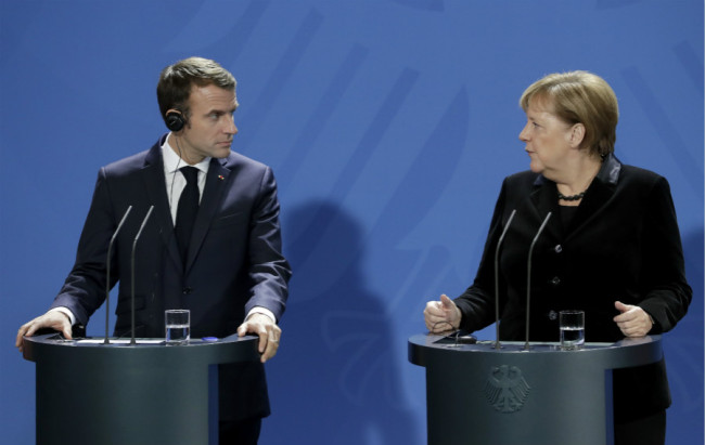 German Chancellor Angela Merkel, right, and France's President Emmanuel Macron, left, address the media during a joint statement prior to a meeting at the chancellery in Berlin, Germany, Sunday, Nov. 18, 2018. [Photo: AP]