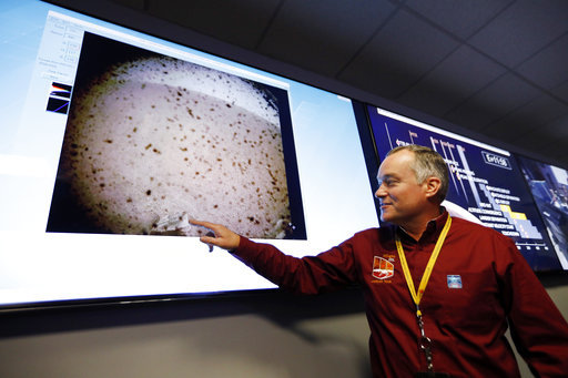 InSight project manager Tom Hoffman points at an image sent from the InSight lander after the space craft landed on Mars in the mission support area of the space flight operation facility at NASA's Jet Propulsion Laboratory Monday, Nov. 26, 2018, in Pasadena, Calif.[Photo:AP]