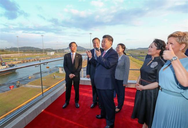 Chinese President Xi Jinping (3rd L) talks via interphone to the captain of Shipping Rose, a vessel of China Ocean Shipping Company (COSCO) which is waiting at the first locks of the Panama Canal, in Panama City, Panama, on Dec. 3, 2018. Accompanied by Panamanian President Juan Carlos Varela, Xi Jinping on Monday paid a visit to the new locks of the Panama Canal. Xi and his wife Peng Liyuan were greeted by Juan Carlos Varela and First Lady Lorena Castillo Garcia when they arrived at the waterway's new locks. [Photo: Xinhua/Xie Huanchi]