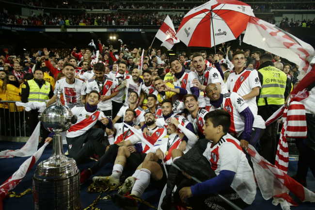 Players of Argentina's River Plate celebrate after defeating Argentina's Boca Juniors in the Copa Libertadores final soccer match at the Santiago Bernabeu stadium in Madrid, Spain, Sunday, Dec. 9, 2018. [Photo: AP]