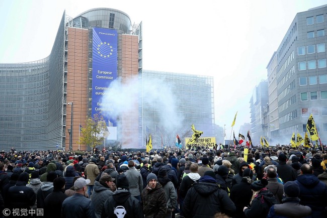 Protesters gather for a demonstration as police officers intervene them near EU buildings in Brussels, Belgium on December 16, 2018.[Photo: VCG]