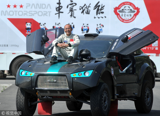 Liang Yuxiang, 62, photographed with his 4 million yuan rally car ahead of the China Around Taklimakan (International) Rally, Chengdu, Sichuan Province, June 11, 2015. [Photo: VCG]